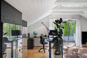 an office with a desk and a plant in a room at Haus Gutschi in Imst