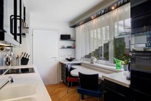 a kitchen with a large window and a sink at Haus Gutschi in Imst +32 photos