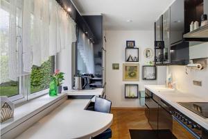 a kitchen with a white counter and a window at Haus Gutschi in Imst