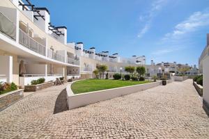 an exterior view of a building with a courtyard at Mare Cheia in Santa Luzia