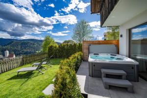 a hot tub on the patio of a house at Chalet Schlossberg Latemar in Nova Ponente +18 photos