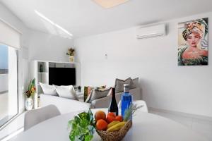 a white living room with a table with fruit on it at Coral 5 in La Santa