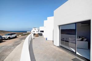 a white building with glass windows on the side of it at Coral 5 in La Santa