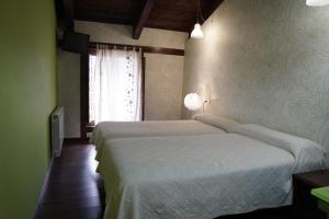 a bedroom with a large bed and a window at La Platería I in Mambrilla de Castrejón