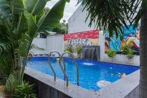 a swimming pool with a mural on the side of a building at Emperor Palace Heritage Villa Udaipur in Udaipur