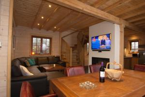 a living room with a couch and a table at Houten villa Albert in Den Ham