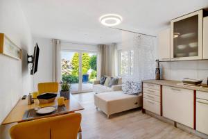 a kitchen and living room with a couch and a table at Easy Living in Tettnang