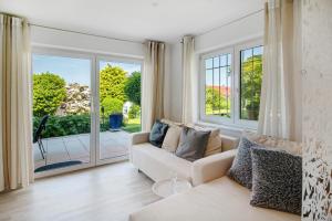 a living room with a couch and large windows at Easy Living in Tettnang