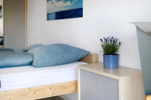 a bedroom with a bed and a table with a potted plant at Easy Living in Tettnang