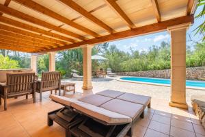 a patio with a pergola and a swimming pool at Finca Biniali in Sencelles