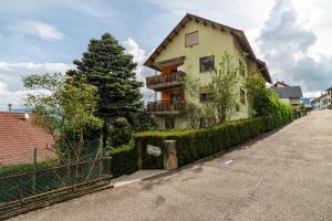 a house with a fence next to a street at Bergblick in Forbach