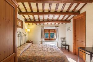 a bedroom with a bed and a table and a chair at Cal Contra in Gélida +36 photos