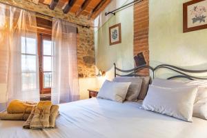 a bedroom with a large white bed with a window at Beb Pulcino Nero Scrofiano in Scrofiano