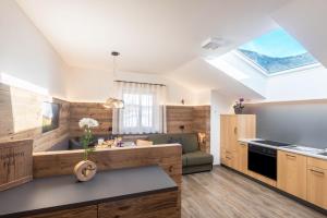 a kitchen with a skylight in the ceiling at Schildberghof Schlernblick in Kastelruth