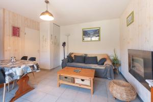a living room with a couch and a table at Gite Clarabide in Loudenvielle