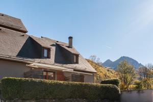 a house with a hedge in front of it at Gite Clarabide in Loudenvielle