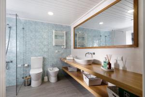 a bathroom with a sink and a toilet and a mirror at Adega do Portinho Velho in Piedade +36 photos