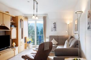 a living room with a couch and a tv at Ferienwohnung Tannenblick 7-4 in Oberhof