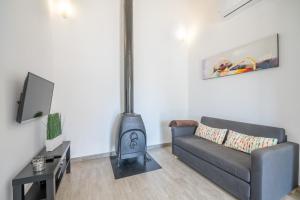 a living room with a couch and a wood stove at Ses Oliveres in Pollença