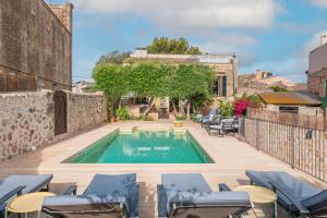 a swimming pool in the middle of a patio with lounge chairs at Numero Uno in Búger