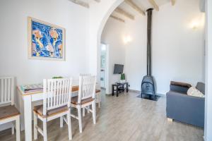 a living room with a couch a table and a stove at Ses Oliveres in Pollença +16 photos