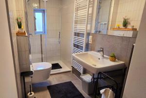 a white bathroom with a sink and a toilet at Salem´s Treasure Manor in Salem +18 photos