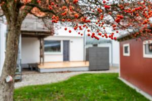 a house with a tree with red berries on it at Salem´s Treasure Manor in Salem