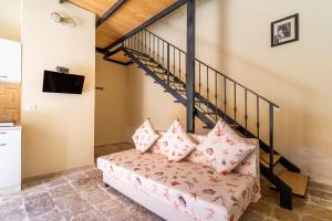 a living room with a couch and stairs at La rimesa di Tittì - Tittì in Alezio