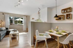 a kitchen and living room with a table and chairs at Ferienwohnung - Arzgebirg in Grünhainichen