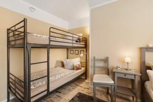 a bedroom with two bunk beds and a desk at Ferienwohnung - Arzgebirg in Grünhainichen