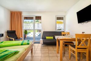 a living room with a couch and a table at Ferienwohnung Buchmann in Deggenhausertal