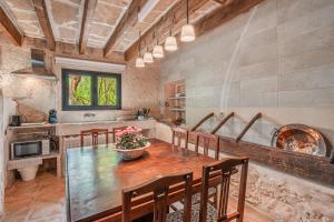 a large kitchen with a wooden table and chairs at Segles 11 in Campos