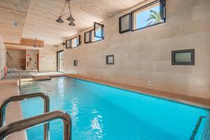 a swimming pool in a house with windows at Segles 11 in Campos