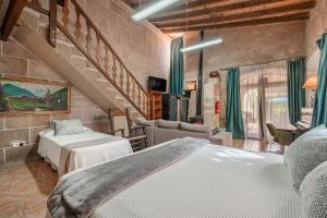 a bedroom with two beds and a staircase at Segles 11 in Campos +17 photos