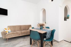a living room with a table and a couch at S' Istancu Vetzu in Irgoli