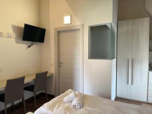 a bedroom with a table and a bed and a desk at Sugadoi in Predazzo