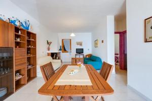 a dining room and living room with a table and chairs at La vista di Mondo in Torre Dei Corsari