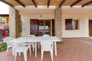 a white table and chairs on a patio at La vista di Mondo in Torre Dei Corsari