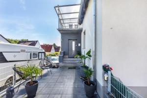 a balcony with potted plants on a building at Ferienwohnug New Look in Geisenheim