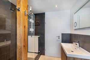 a bathroom with a sink and a mirror at Ferienwohnug New Look in Geisenheim +22 photos