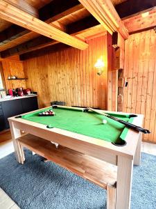 a pool table in a room with a pool at Chalet Mouflon - Vue lac imprenable in Thollon