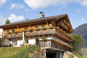 a large wooden house with balconies on a mountain at Oberhof Apt Panorama in Vallarga +17 photos