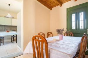 a kitchen and dining room with a table and chairs at Avra in EFL +22 photos