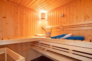 a person laying in the inside of a sauna at Ferienhaus Seepferdchen in Dranske