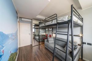 a room with bunk beds and a mural on the wall at Resort Style Apartment in Perledo +20 photos