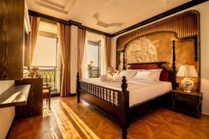 a bedroom with a large bed and a balcony at Cao Boutique Hotel in Thôn Trường Giang +152 photos