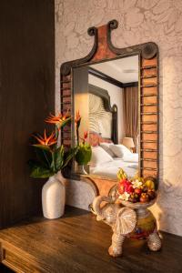 a mirror sitting on a table in a bedroom at Cao Boutique Hotel in Thôn Trường Giang