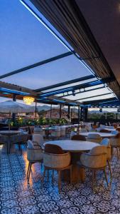 a restaurant with tables and chairs and a view at Casa Leon Hotel R Top in Rionegro