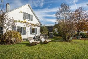 a group of chairs in the yard of a house at Ferienhaus Landlust-Karsee in Wangen im Allgäu