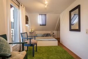 a bedroom with a bed and a table and a mirror at Ferienhaus Landlust-Karsee in Wangen im Allgäu